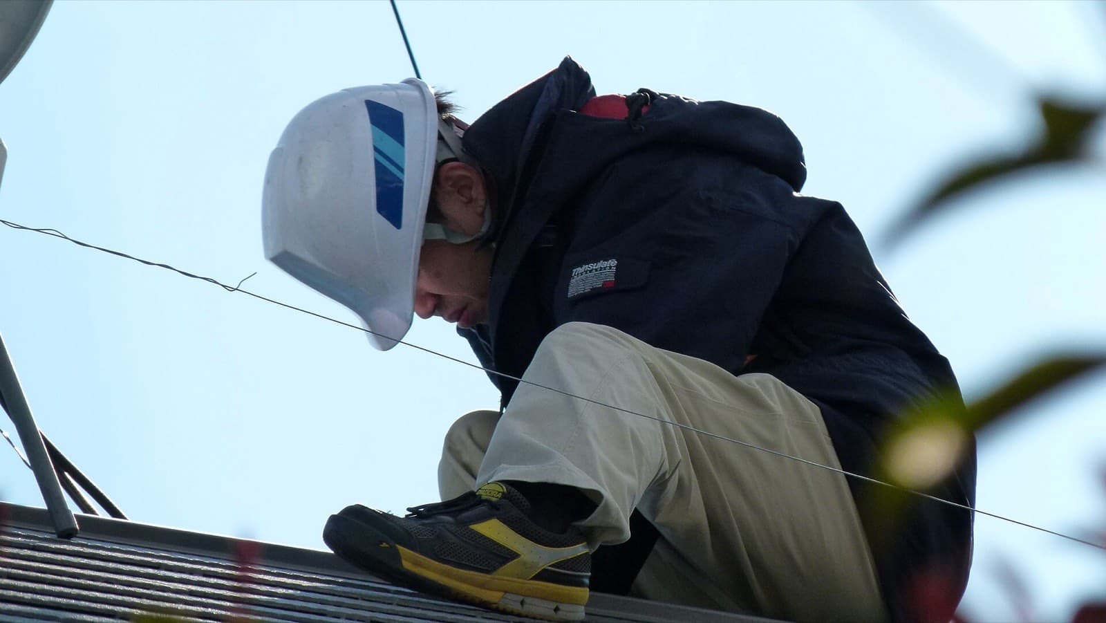 Technician installing rooftop solar panels
